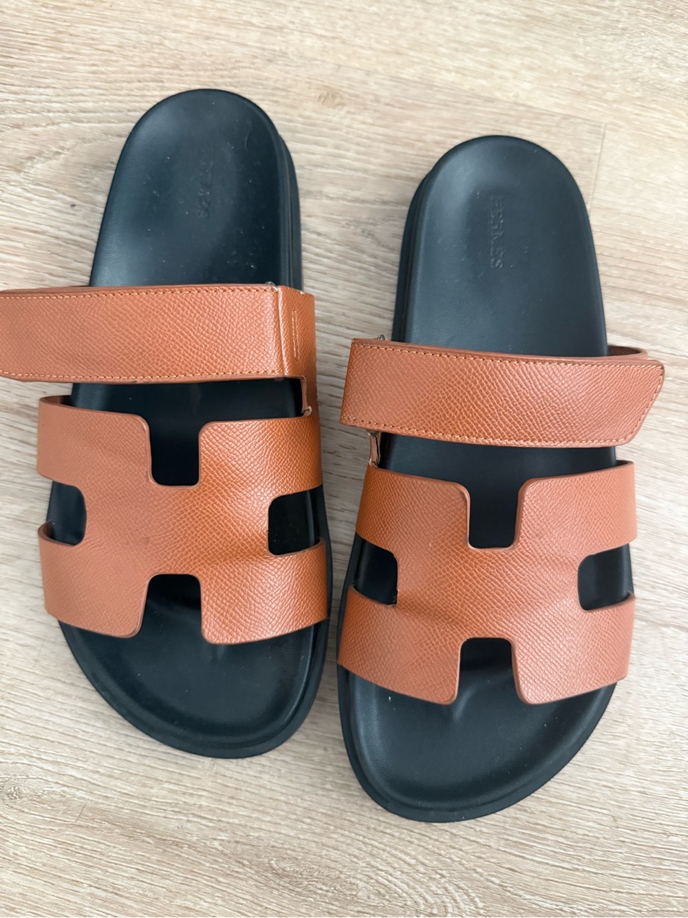 Hermes Womenโs Brown Leather Slide Sandals with Black Footbed